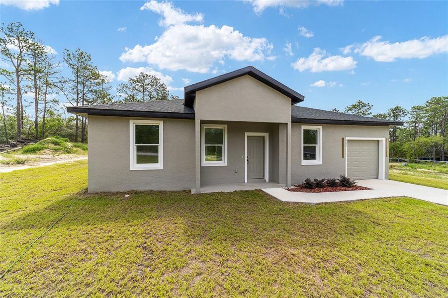 Front exterior of a new home in , Dunnellon, FL, highlighting curb appeal (Image 2). Front exterior of a new home in , Dunnellon, FL, highlighting curb appeal (Image 2).