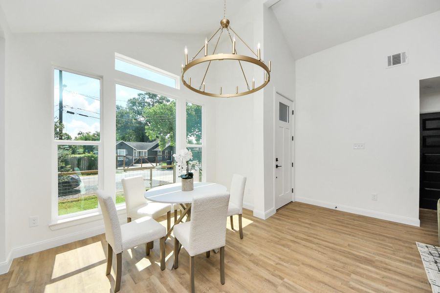 A sleek modern chandelier sets the tone for both casual dinners and special celebrations. Gather around the table as golden sunlight pours in through expansive window. The open layout flows effortlessly into a cozy sitting area—ideal for lingering conversations, entertaining guests, or enjoying quiet moments with family. A sleek modern chandelier sets the tone for both casual dinners and special celebrations. Gather around the table as golden sunlight pours in through expansive window. The open layout flows effortlessly into a cozy sitting area—ideal for lingering conversations, entertaining guests, or enjoying quiet moments with family.