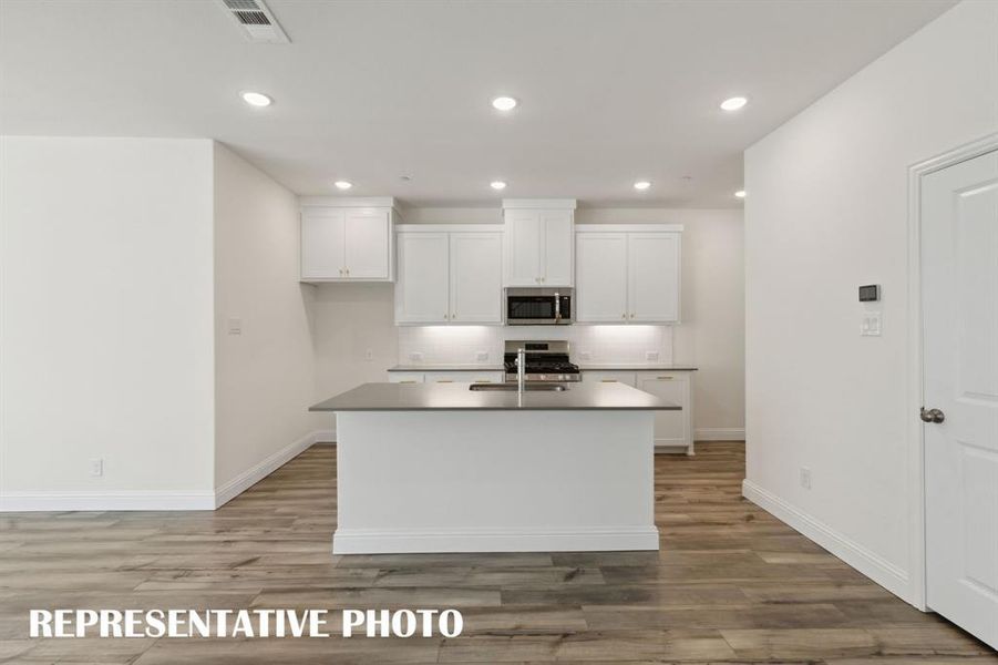 A spacious kitchen island is center stage in this dream kitchen!  REPRESENTATIVE PHOTO