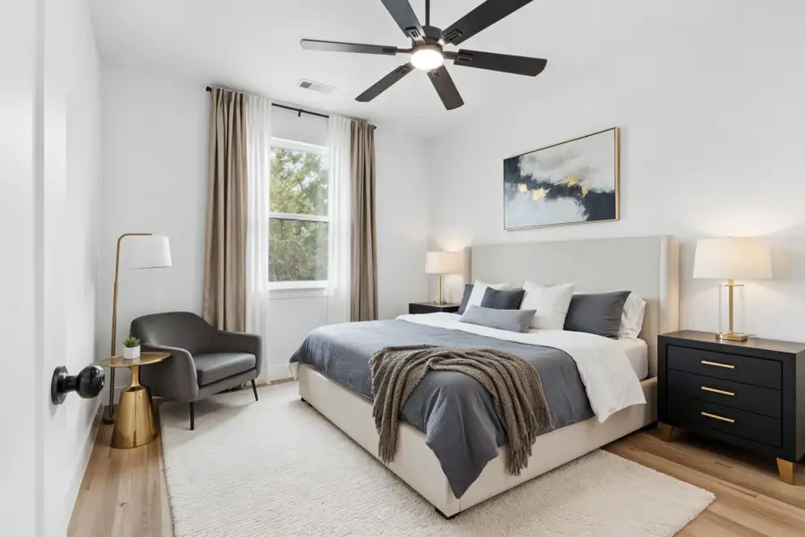 Virtually staged Secondary Bedroom with light wood-style floors and ceiling fan