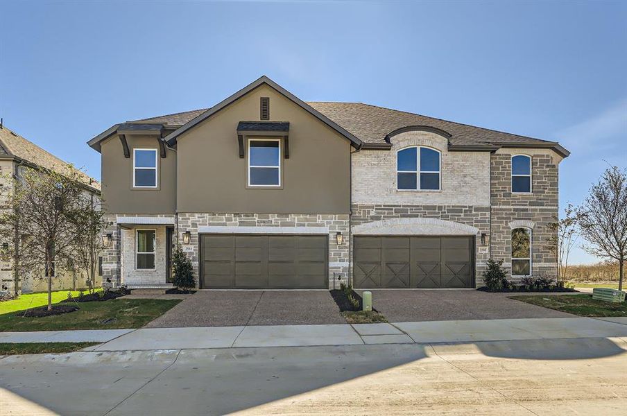 French provincial home featuring a garage