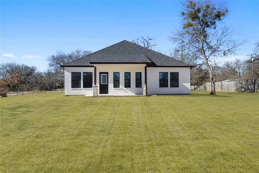 Rear view of house with a lawn