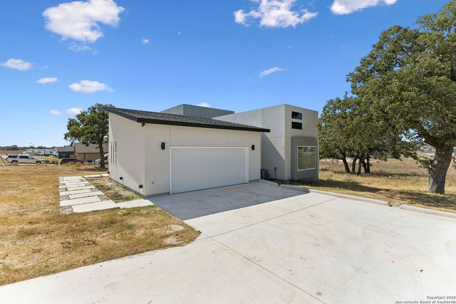 Front exterior of a new home in , La Vernia, TX, highlighting curb appeal (Image 1).