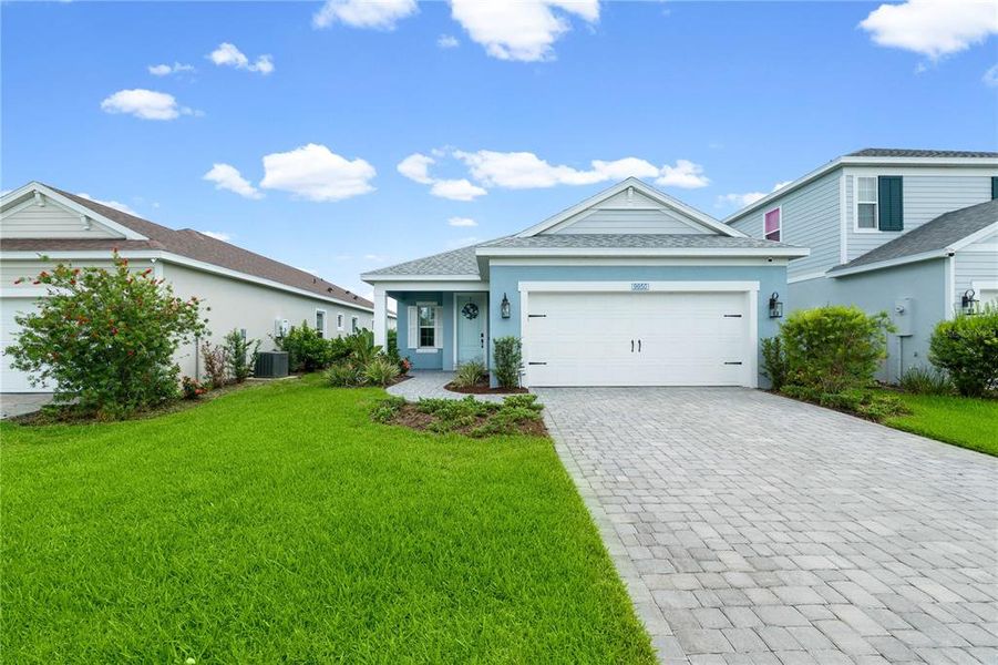 Front exterior of a new home in Wildleaf at North River Ranch, Parrish, FL, highlighting curb appeal (Image 22). Front exterior of a new home in Wildleaf at North River Ranch, Parrish, FL, highlighting curb appeal (Image 22).