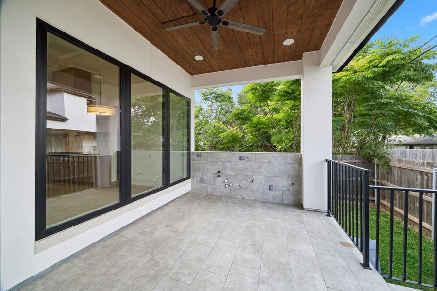 As a transition to your outdoor entertainment area, the 16x10 covered porch is tiled and pre-plumbed to receive a sink and has a gas connection.