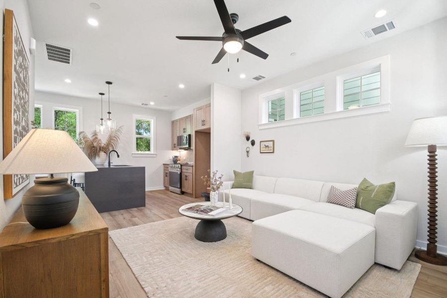 An open-concept living space integrates kitchen and lounge areas, featuring LVP flooring and clean lines. An open-concept living space integrates kitchen and lounge areas, featuring LVP flooring and clean lines.
