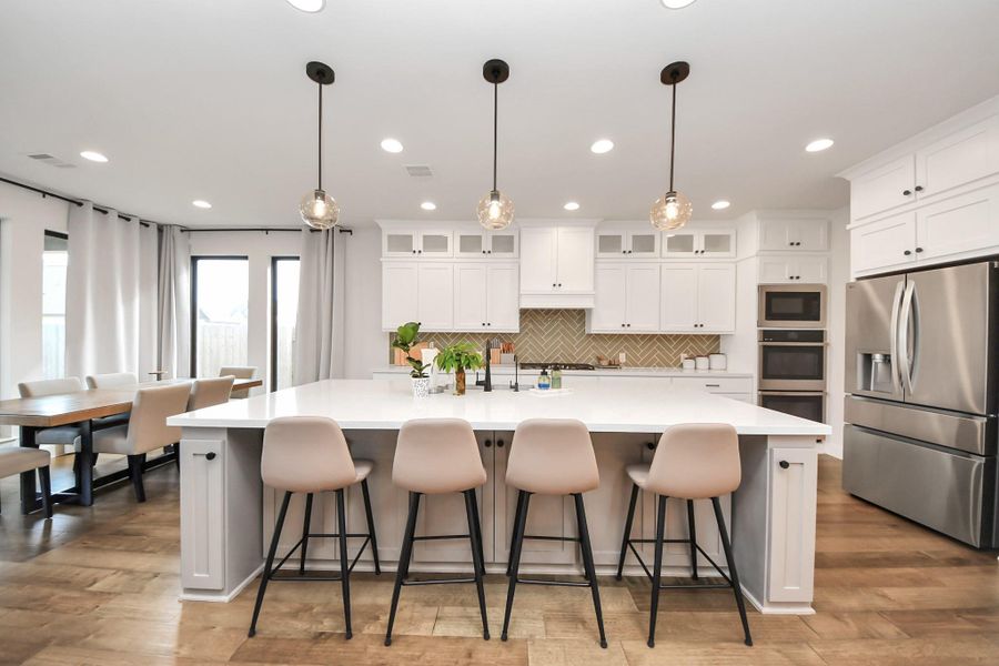Expansive kitchen with large center island and ample seating.