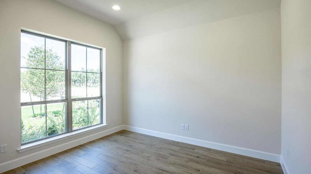 Spare room with plenty of natural light, dark wood-style floors, recessed lighting, and vaulted ceiling Spare room with plenty of natural light, dark wood-style floors, recessed lighting, and vaulted ceiling