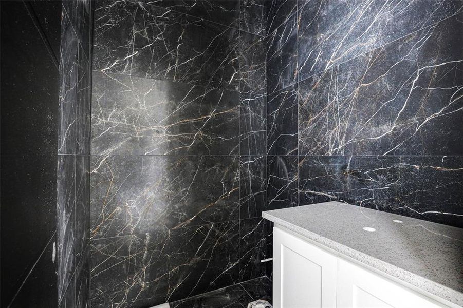 Bathroom with sink and tile patterned flooring