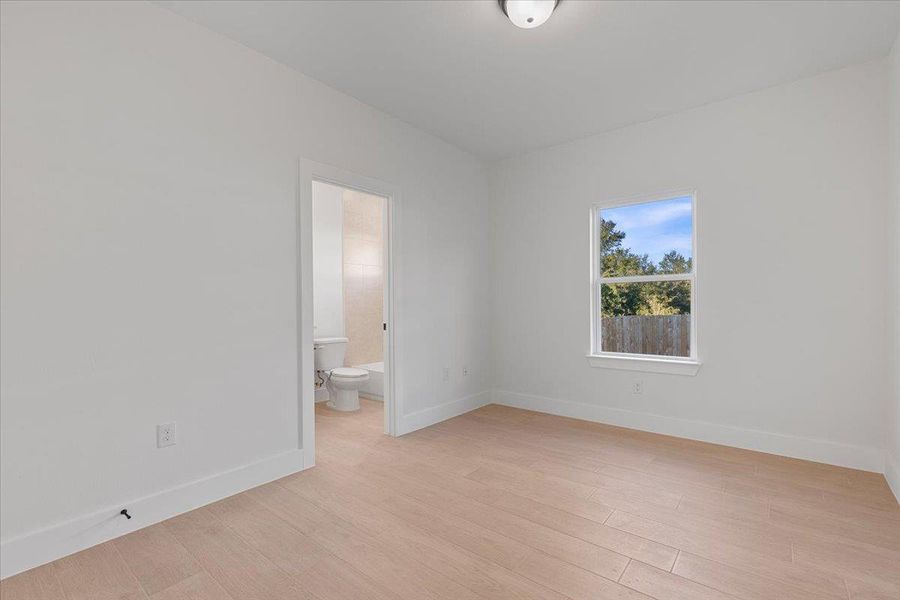 Unfurnished room featuring baseboards and light wood-style flooring Unfurnished room featuring baseboards and light wood-style flooring