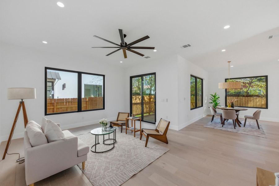 Living room featuring recessed lighting, light wood finished floors, and ceiling fan