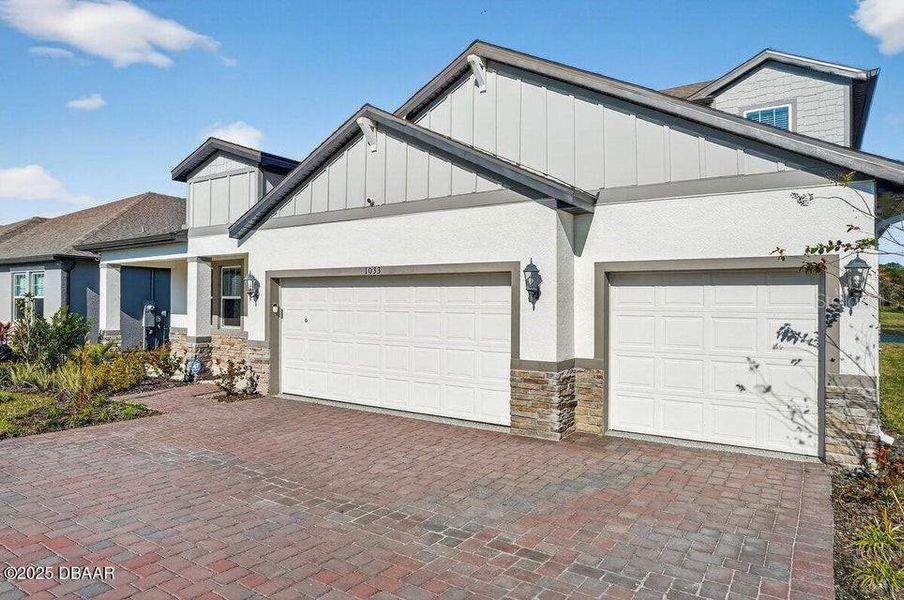 Front exterior of a new home in Legends Preserve - Reserve Series, Daytona Beach, FL, highlighting curb appeal (Image 24). Front exterior of a new home in Legends Preserve - Reserve Series, Daytona Beach, FL, highlighting curb appeal (Image 24).