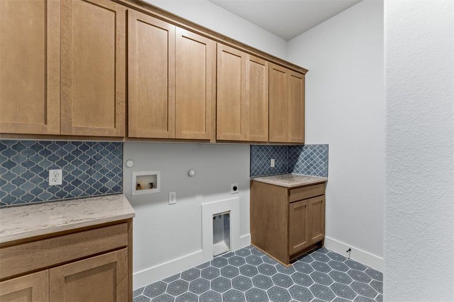 Laundry room featuring gas dryer hookup, hookup for a washing machine, hookup for an electric dryer, and cabinet space