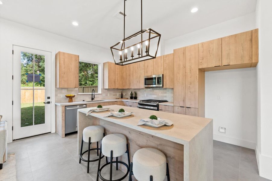 Arcadia Yellow Walnut cabinetry with Artic White with Coral Luster Quartz Countertops.*All photos are from the previous phase*