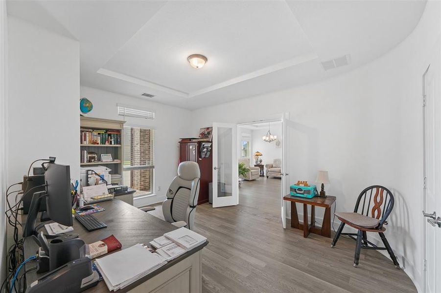 Downstairs office features double glass doors
