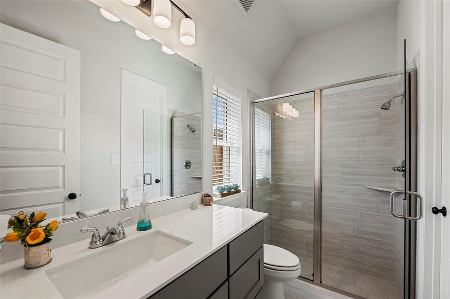 This bedroom has its own full bathroom