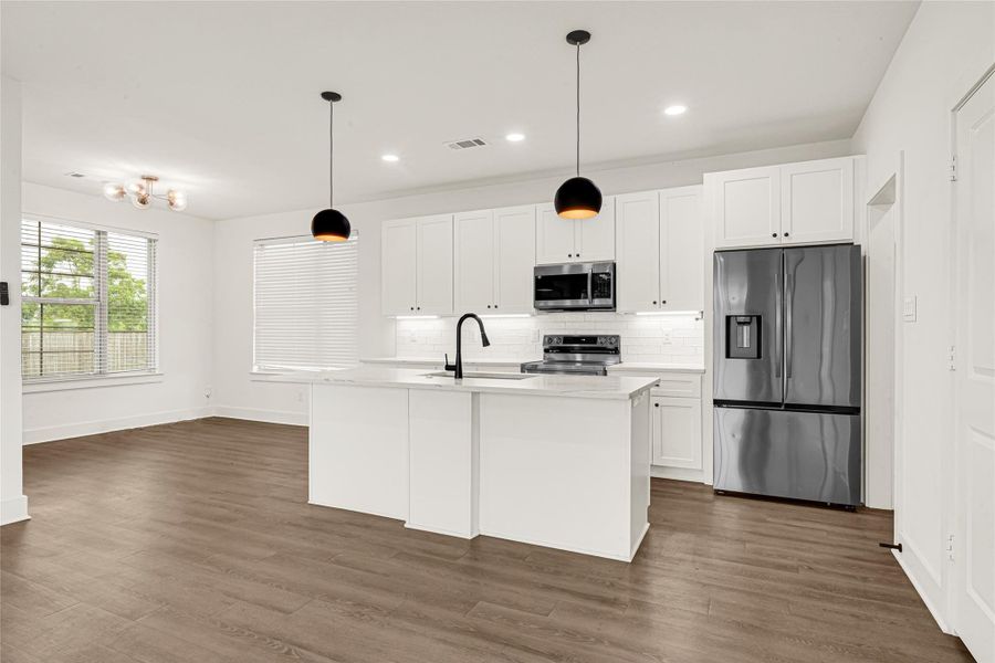This bright and open-concept kitchen and dinning space offers a seamless blend of style and functionality, perfect for everyday living and entertaining. The spacious dinning area is filled with natural light from oversized windows, creating an inviting setting for gatherings.