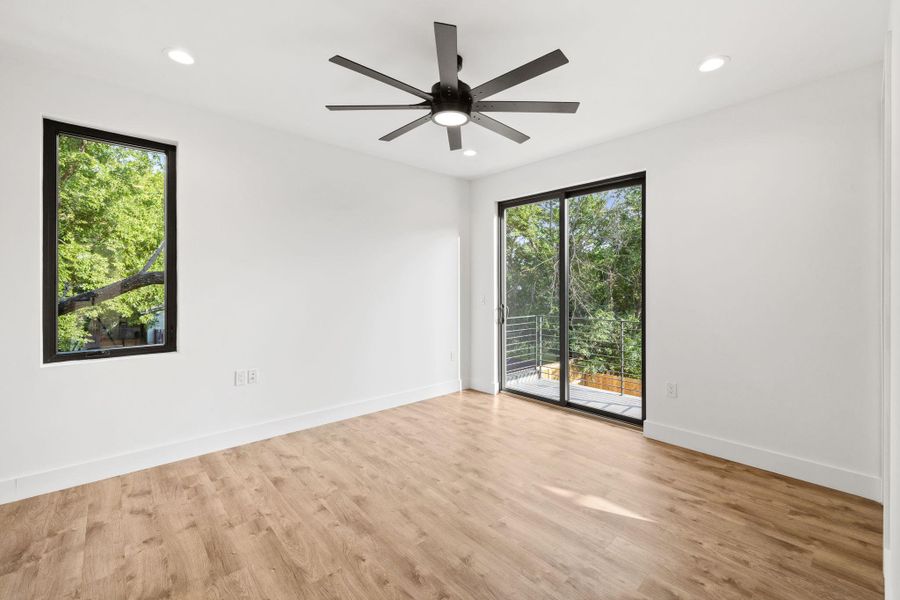 Glass sliding door at primary bedroom leads to balcony