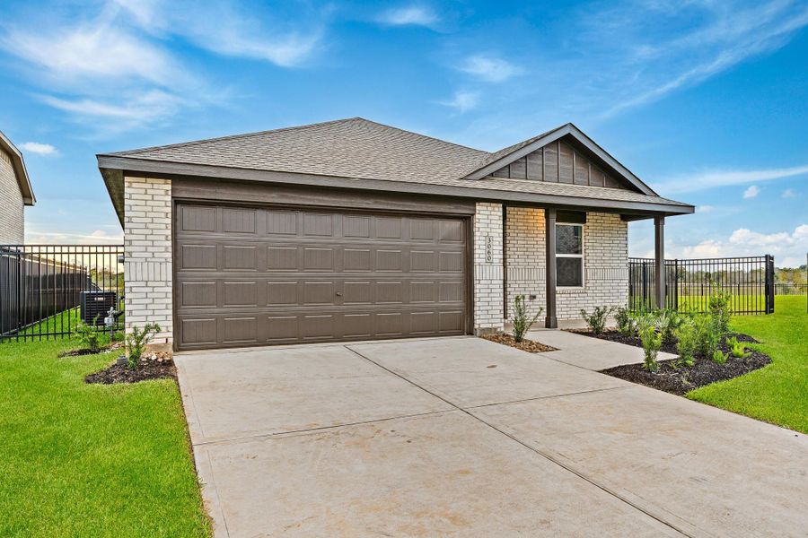 Front exterior of a new home in Sunterra, Katy, TX, highlighting curb appeal (Image 14). Front exterior of a new home in Sunterra, Katy, TX, highlighting curb appeal (Image 14).