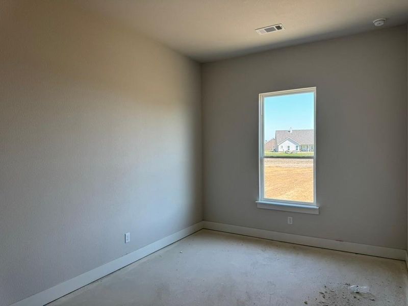 Spare room featuring baseboards