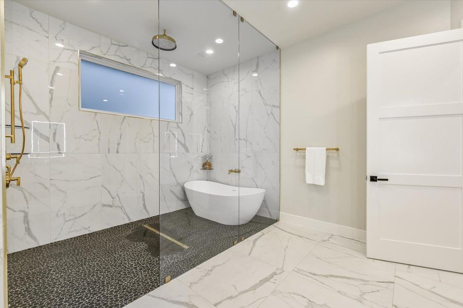 Bathroom with a marble finish shower, recessed lighting, light marble finish floors, and a freestanding bath