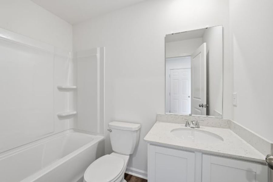 A bathroom with a sink toilet and bathtub.