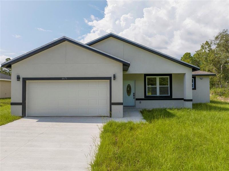 Front exterior of a new home in , Ocala, FL, highlighting curb appeal (Image 2). Front exterior of a new home in , Ocala, FL, highlighting curb appeal (Image 2).
