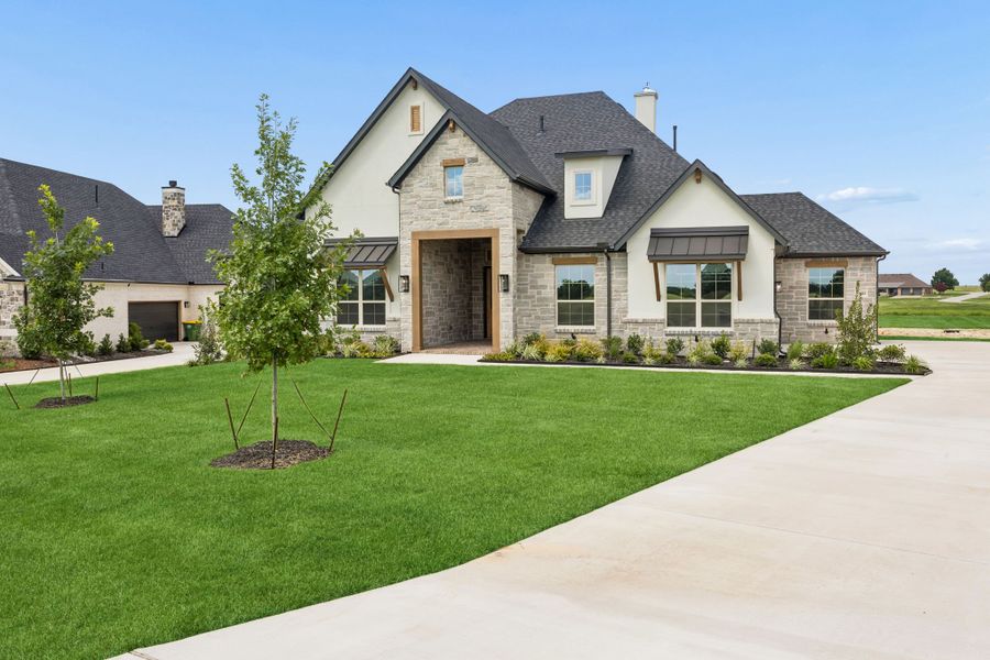 Front exterior of a new home in The Retreat, Cleburne, TX, highlighting curb appeal (Image 1). Front exterior of a new home in The Retreat, Cleburne, TX, highlighting curb appeal (Image 1).