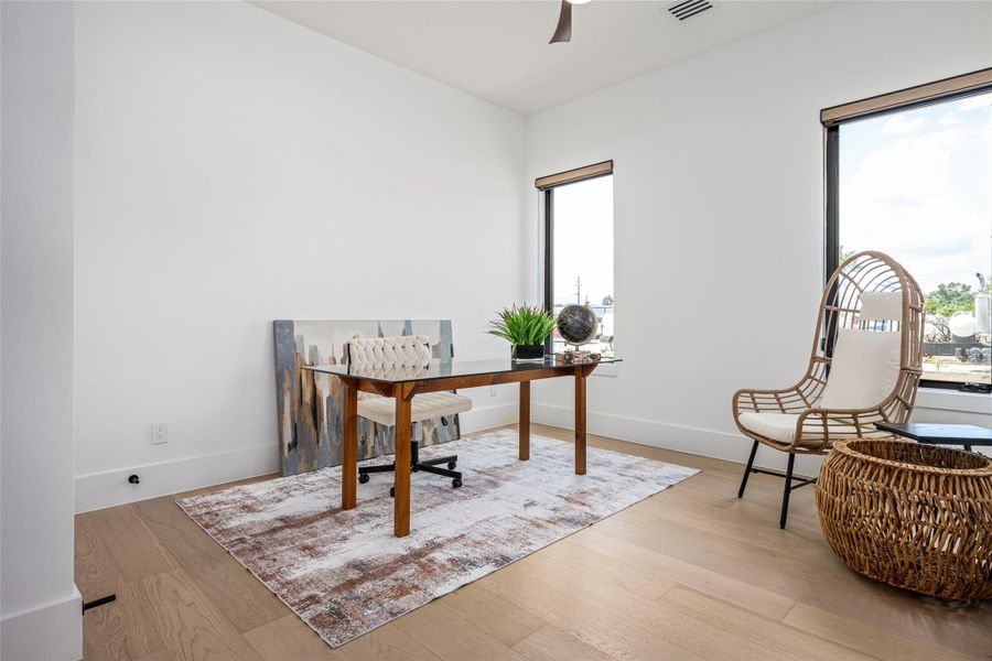 A flexible downstairs bedroom offers space for guests or a home office—complete with a custom closet and access to a designer full bath A flexible downstairs bedroom offers space for guests or a home office—complete with a custom closet and access to a designer full bath