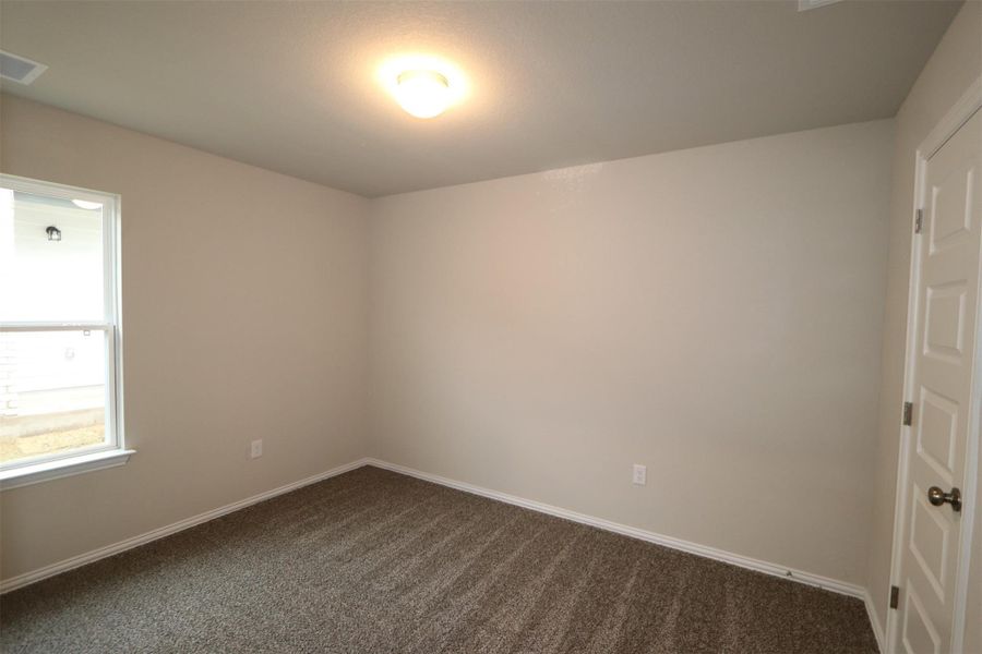 Unfurnished room with dark carpet