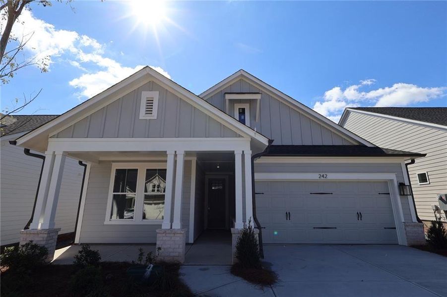 Front exterior of a new home in Maple Grove at Towne Lake, Woodstock, GA, highlighting curb appeal (Image 1).