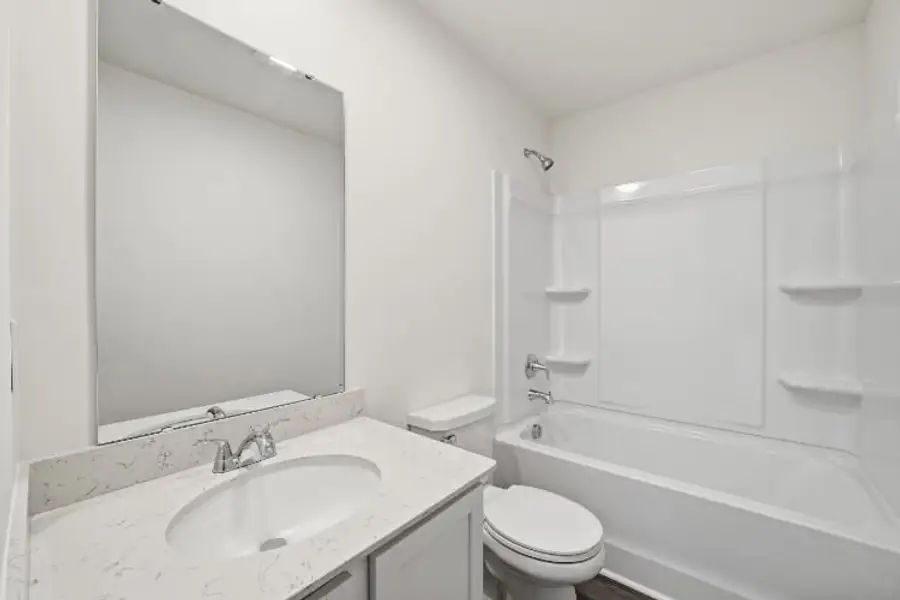 A bathroom with a sink toilet and bathtub. A bathroom with a sink toilet and bathtub.