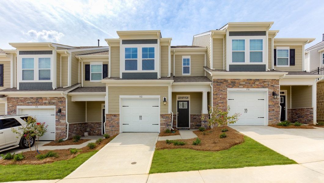 Front exterior of a new home in Townes at Tap Root Farms, Fletcher, NC, highlighting curb appeal (Image 1). Front exterior of a new home in Townes at Tap Root Farms, Fletcher, NC, highlighting curb appeal (Image 1).