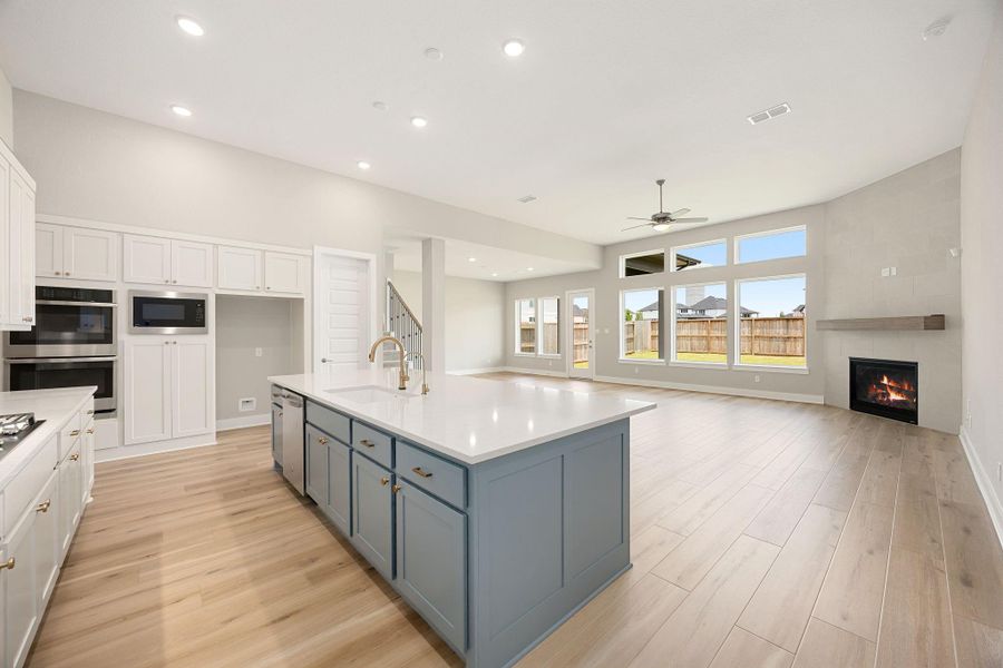 Open-concept living shines here, with the kitchen island overlooking the living area and backyard views — perfect for entertaining. Open-concept living shines here, with the kitchen island overlooking the living area and backyard views — perfect for entertaining.