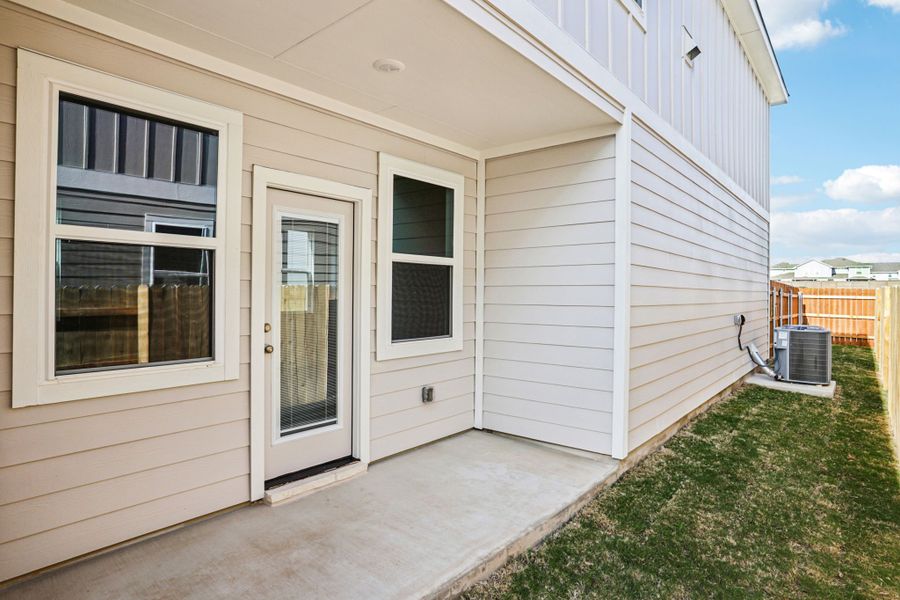 A white house with a green lawn.