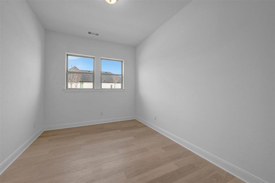 Empty room featuring light wood-style flooring and baseboards