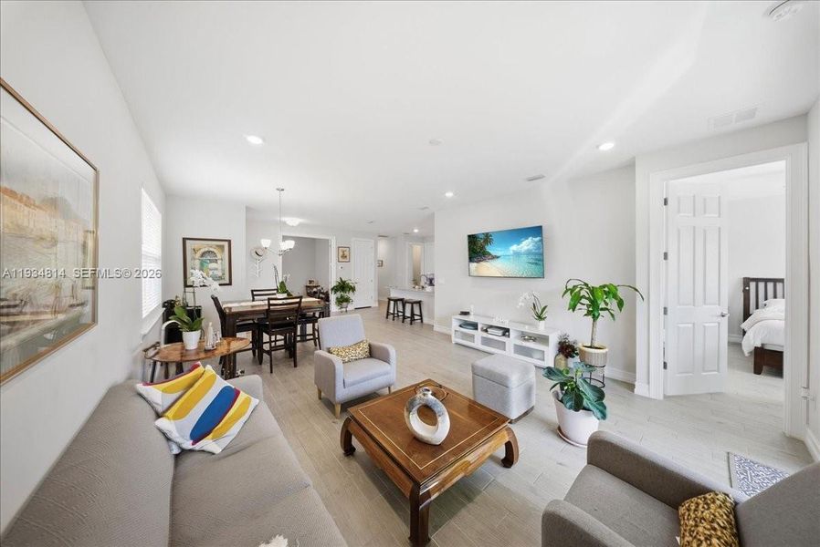 with recessed lighting and light wood-style tile flooring