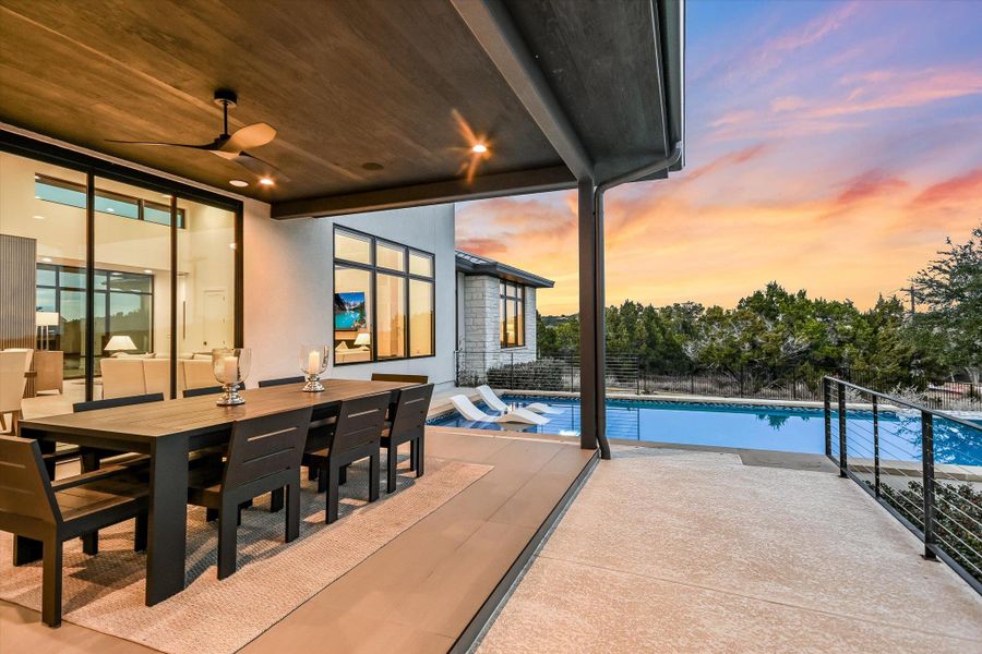 Pool at dusk featuring an outdoor pool, outdoor dining space, and a patio Pool at dusk featuring an outdoor pool, outdoor dining space, and a patio