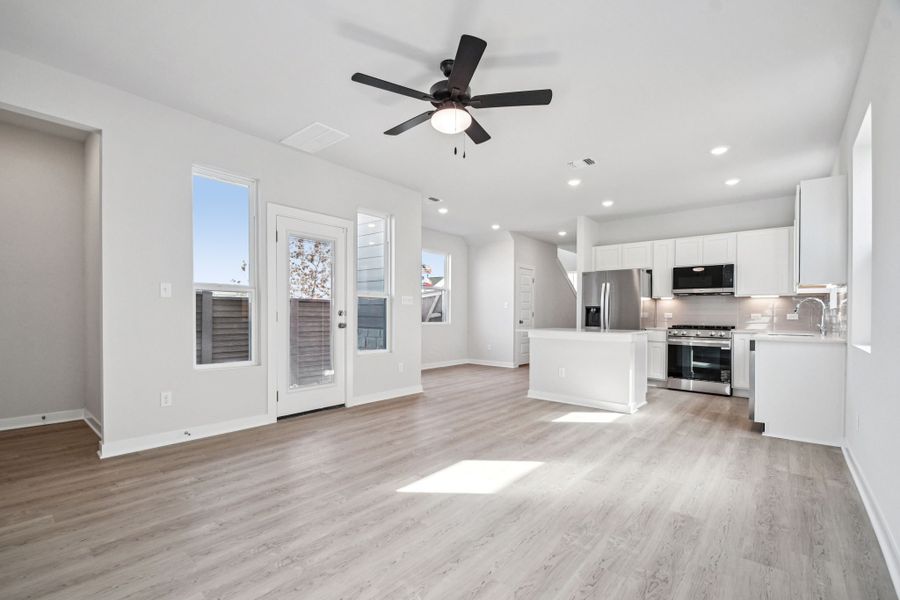 A kitchen with white cabinets.