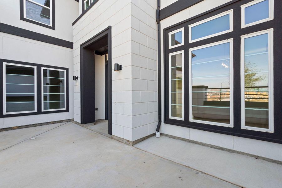 Representative example of how the home will look. Spectacular entry courtyard welcomes guests.