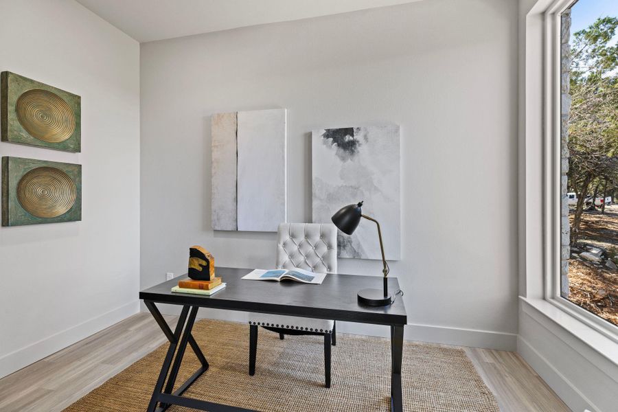 Office space featuring baseboards and light wood finished floors