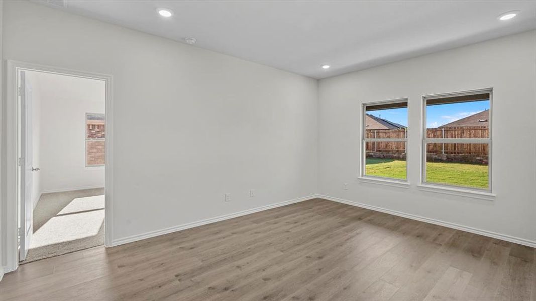 Spare room with wood finished floors and recessed lighting