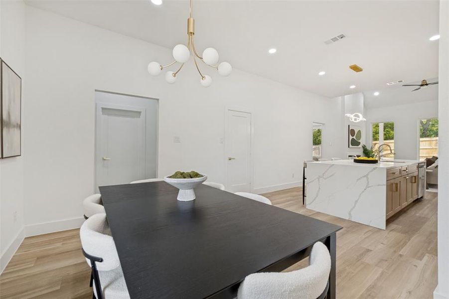 Open-concept living area with light wood-finish flooring Open-concept living area with light wood-finish flooring