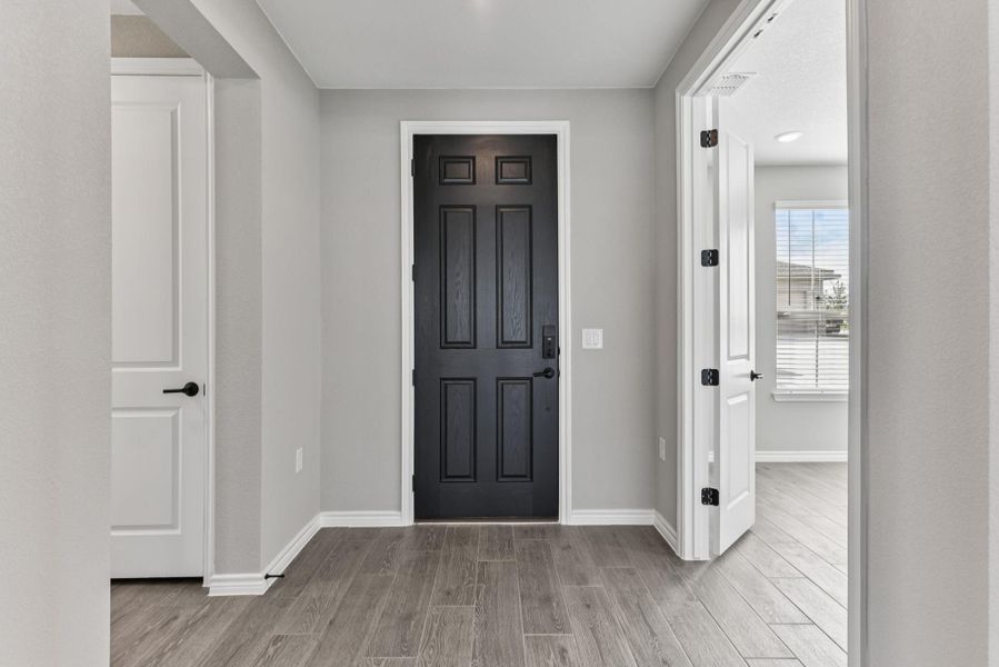 Foyer featuring wood tiled floors and baseboards