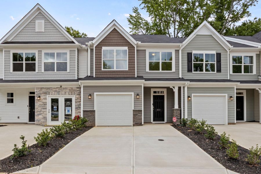 Front exterior of a new home in East Main Townes, Spartanburg, SC, highlighting curb appeal (Image 1). Front exterior of a new home in East Main Townes, Spartanburg, SC, highlighting curb appeal (Image 1).