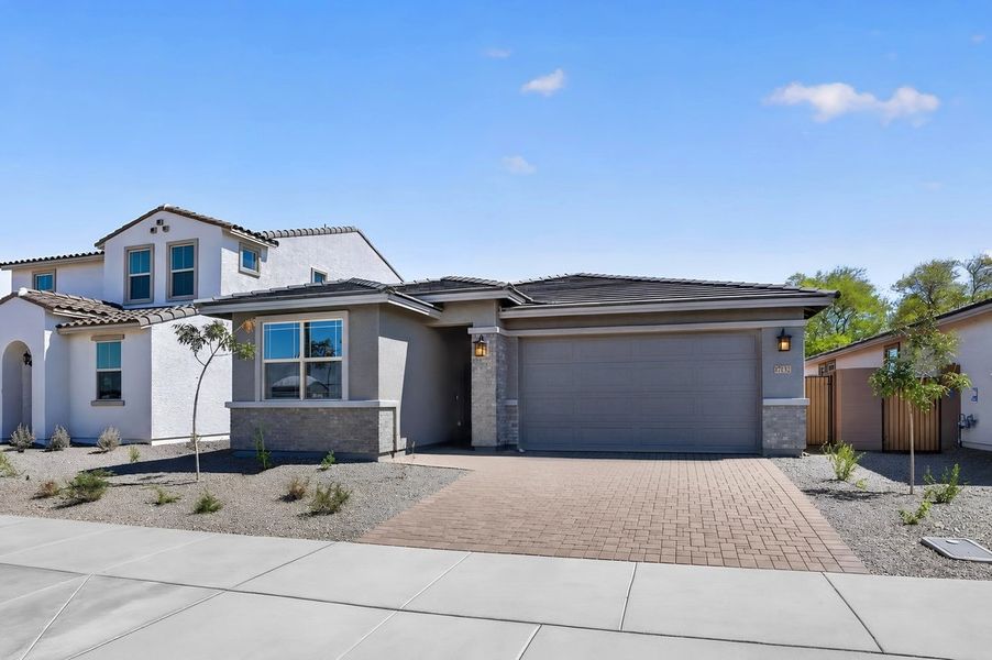 Front exterior of a new home in Artisan at Asante, Surprise, AZ, highlighting curb appeal (Image 18).