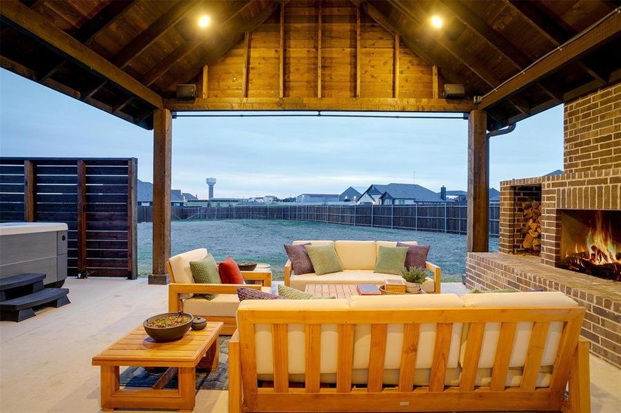 View of patio with an outdoor living space with a fireplace and a water view