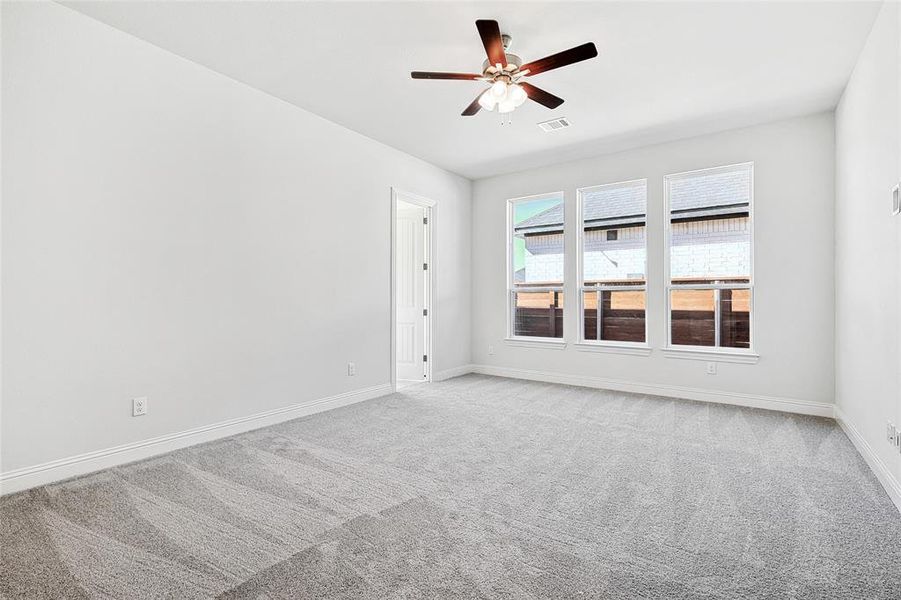Spare room with carpet flooring and ceiling fan