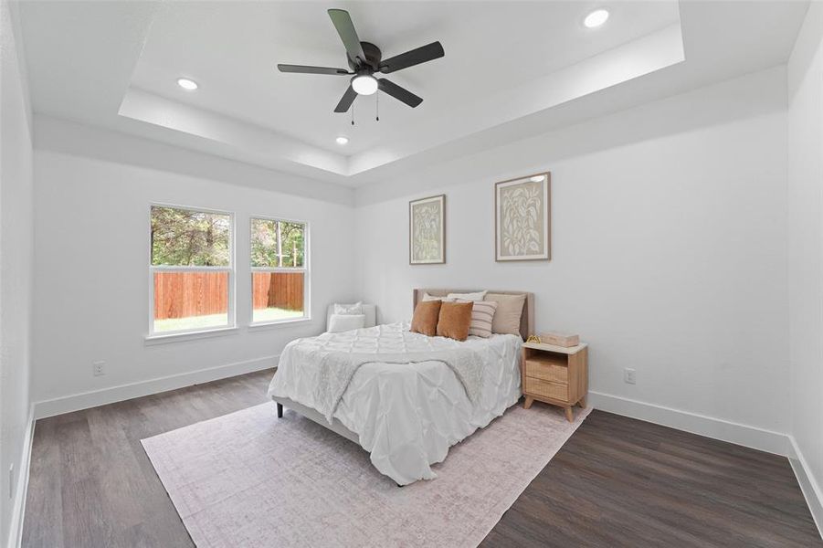 Recessed lighting and a ceiling fan illuminate a tray ceiling Recessed lighting and a ceiling fan illuminate a tray ceiling