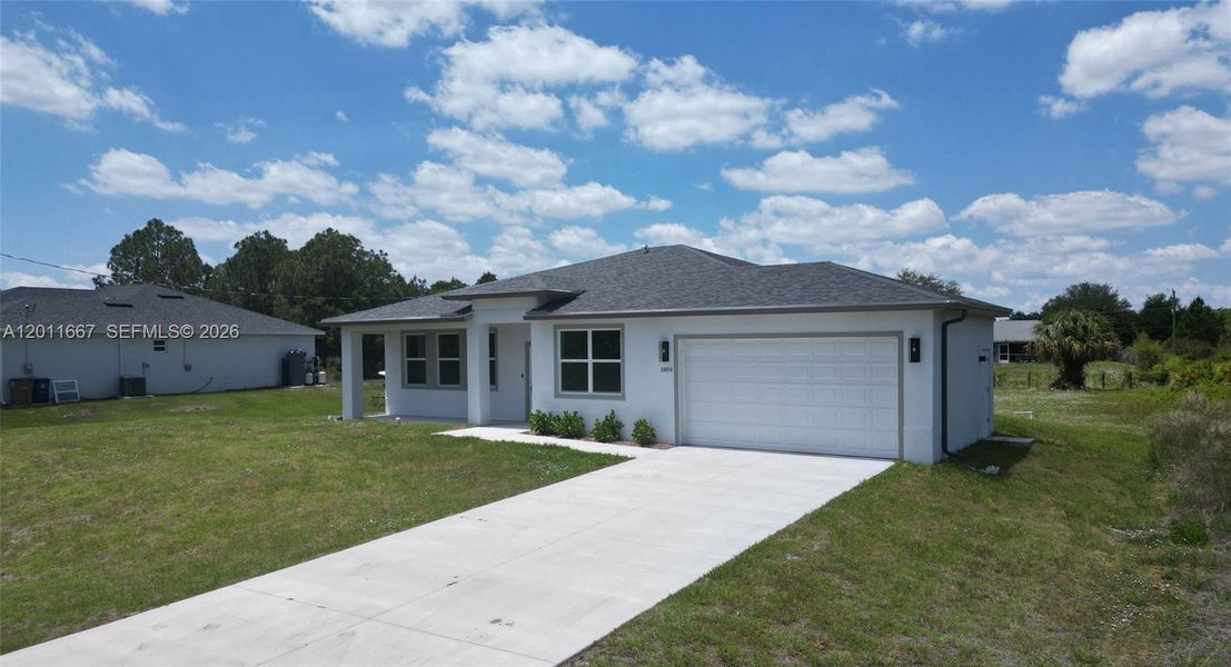 Front exterior of a new home in , Lehigh Acres, FL, highlighting curb appeal (Image 2). Front exterior of a new home in , Lehigh Acres, FL, highlighting curb appeal (Image 2).